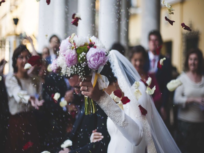 Beautiful wedding moment with bride holding bouquet and confetti falling - capture every precious moment with Pixilia